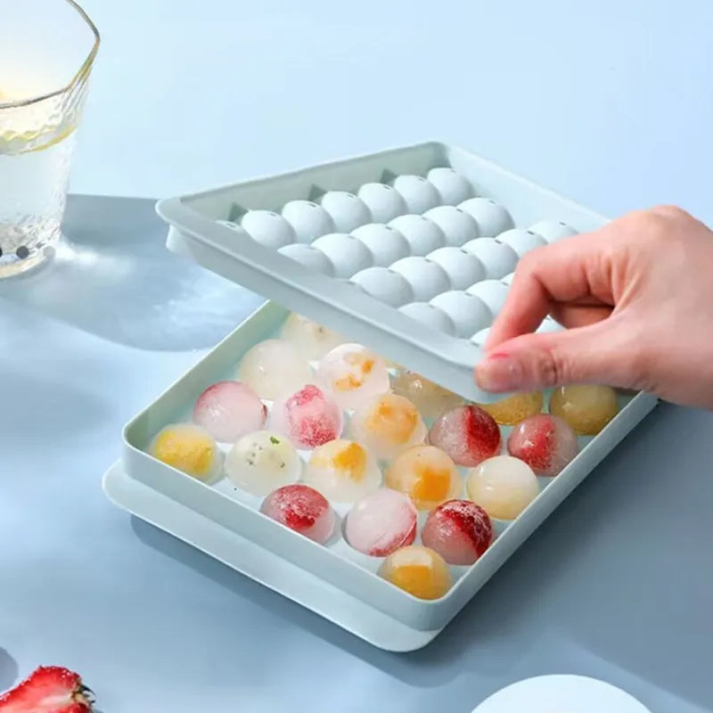 Blue silicone ice cube tray with 33 round cavities and clear snap-on lid