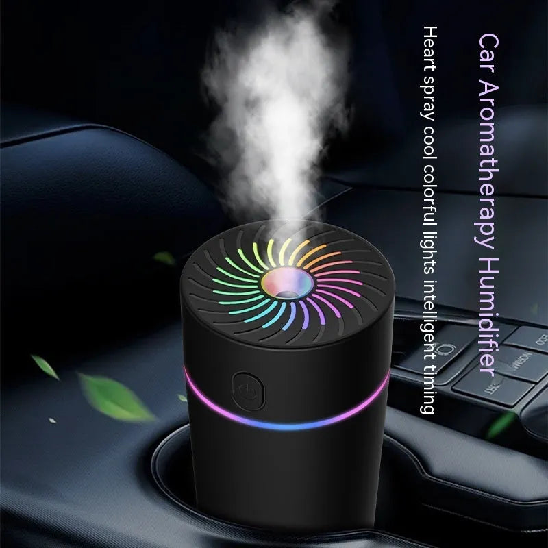 Compact black car USB humidifier with aromatherapy function placed in a vehicle cup holder.