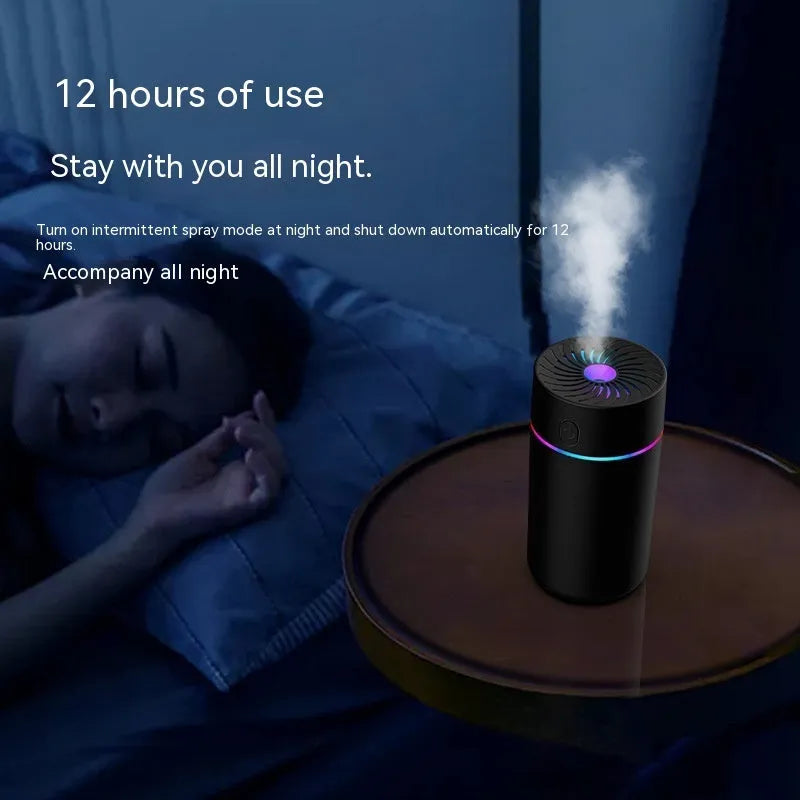Compact black car USB humidifier with aromatherapy function placed in a vehicle cup holder.