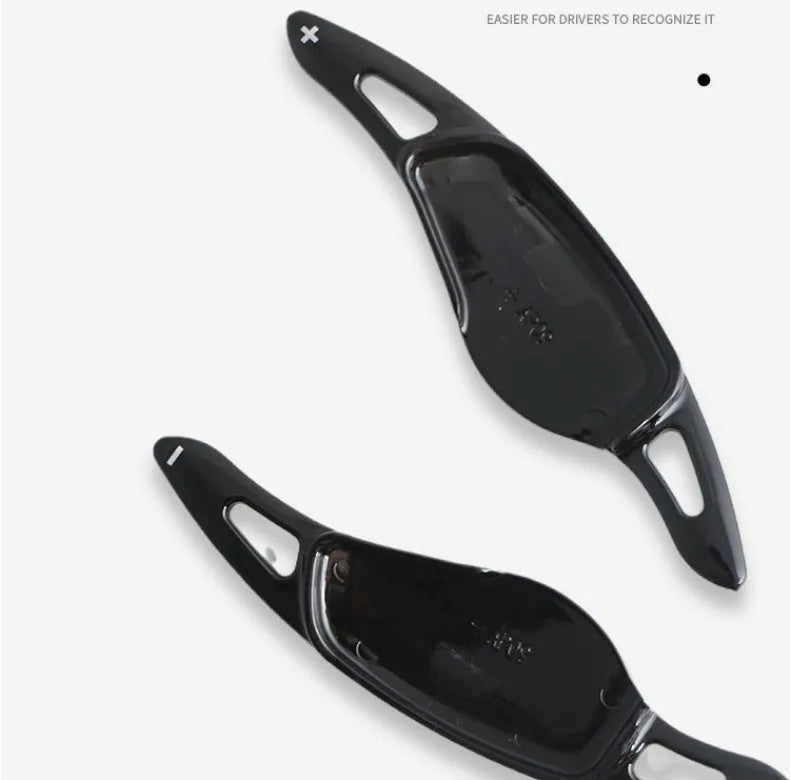 Steering wheel shift paddle modification kit in ABS plastic showing carbon fibre black and red finish options.