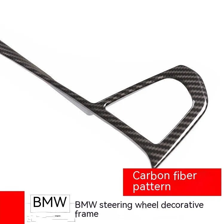 BMW steering wheel button frame decoration with black carbon fibre pattern finish.