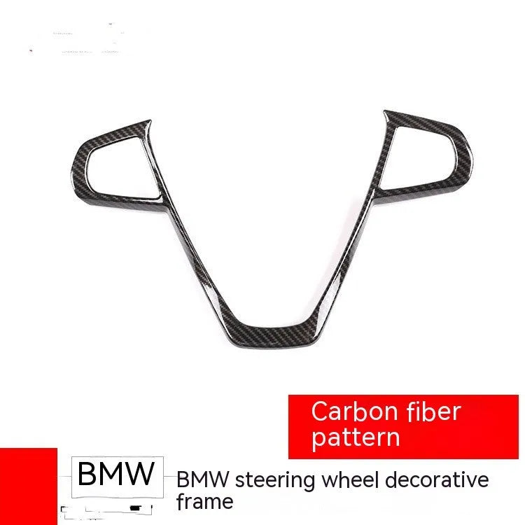 BMW steering wheel button frame decoration with black carbon fibre pattern finish.
