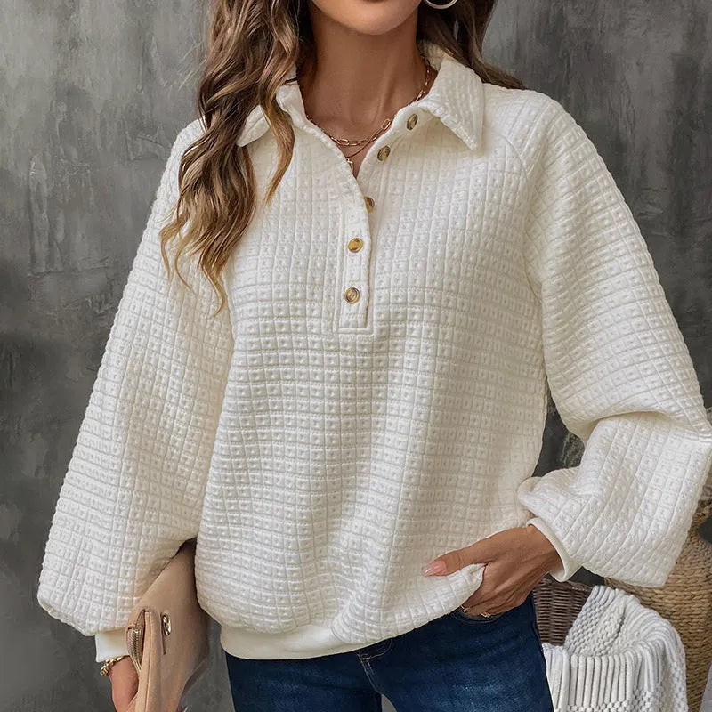 Beige women's knitted sweater with a polo collar and long sleeves laid flat.