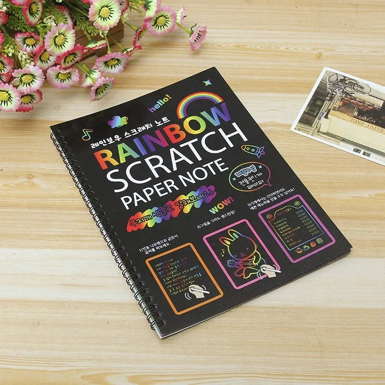 Large colourful children's scratch art paper measuring 26 by 19 centimetres with scraping tool.