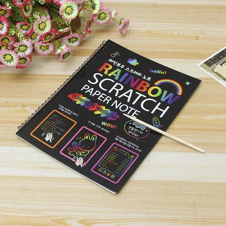 Large colourful children's scratch art paper measuring 26 by 19 centimetres with scraping tool.