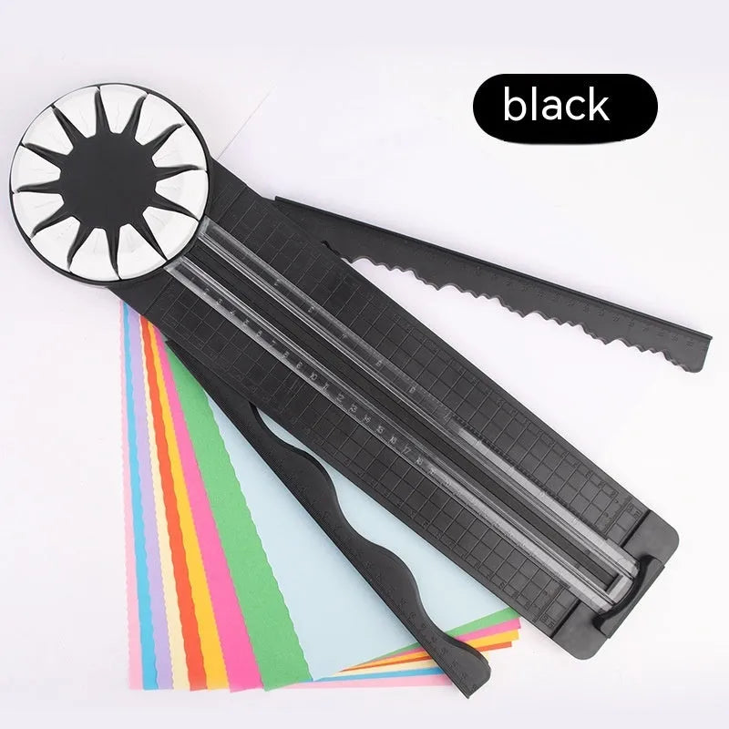 Pink plastic 12-in-1 paper cutting machine with dotted perforation wheel on craft table