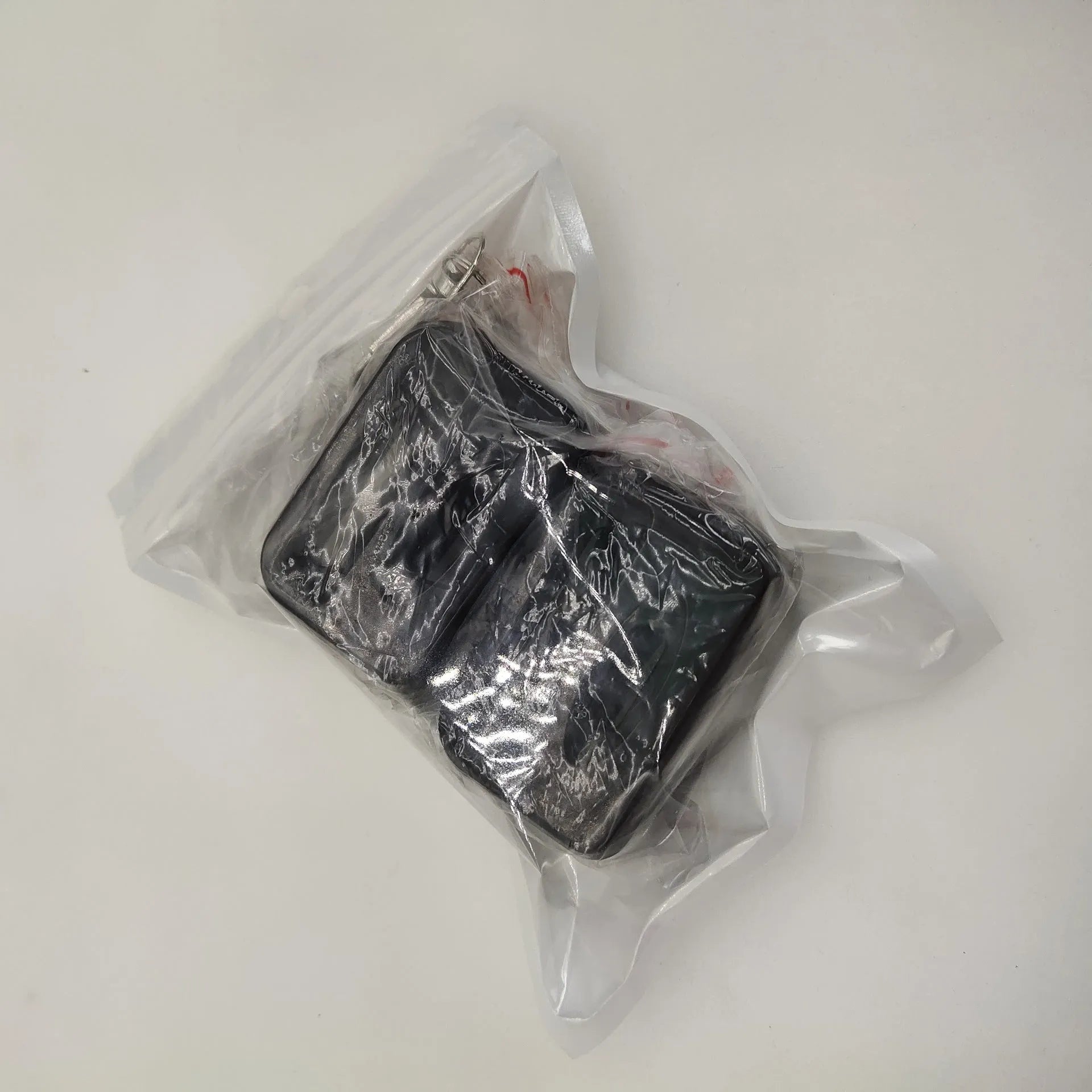 Black plastic seat belt lock protective device clipped onto vehicle seat belt buckle