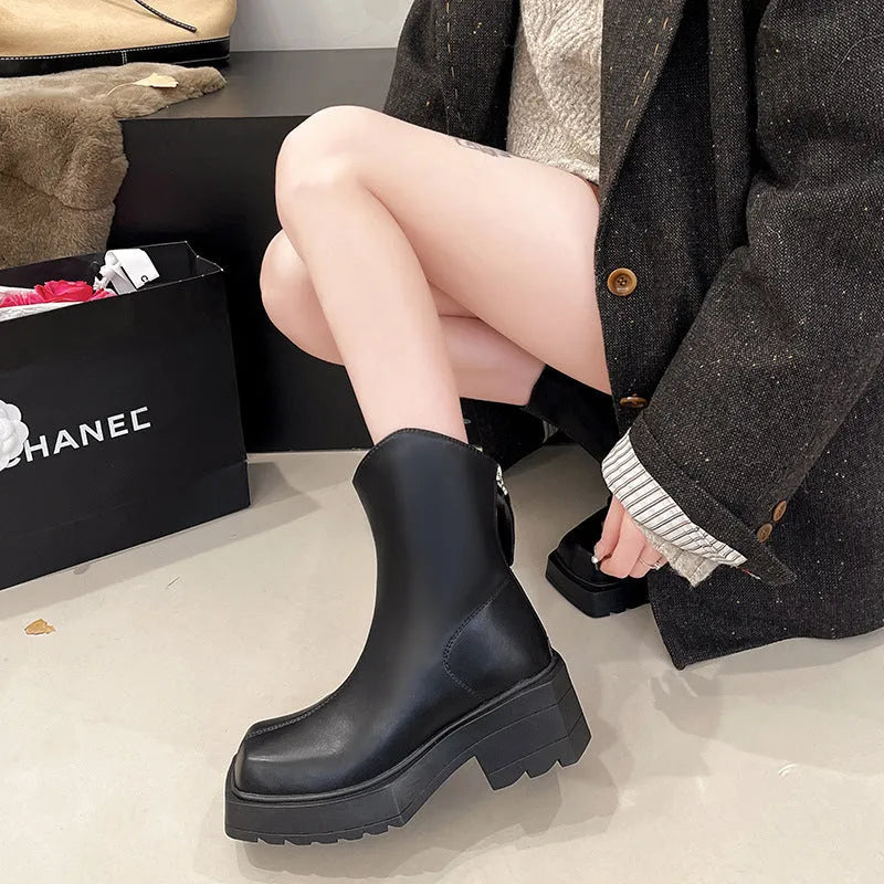 Black women's platform Martin boots with a square toe, mid-calf height, and a back zip.