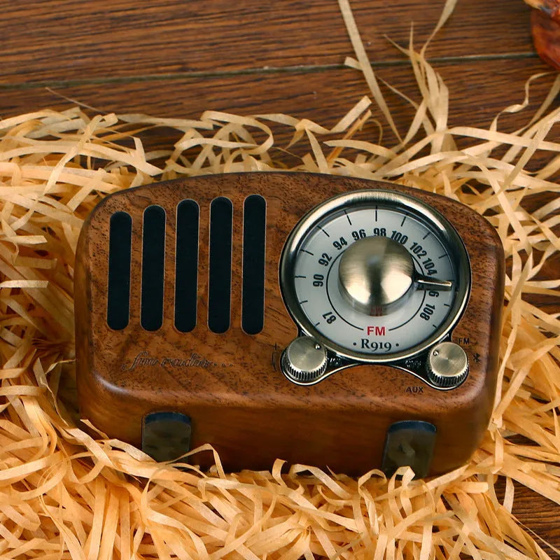 Compact retro wooden Bluetooth mini speaker in cherry wood finish showing front grille and wood grain.