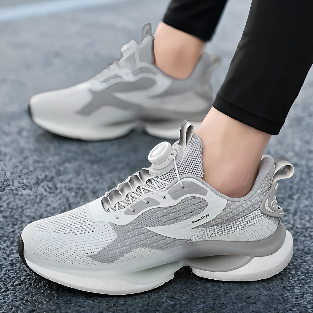 Men's low-top sports shoes with a rotating buckle closure and mesh uppers in a solid colour.