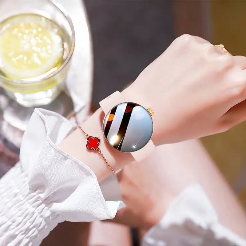 Circular smartwatch for women with metal strap and colour touchscreen on a wrist.