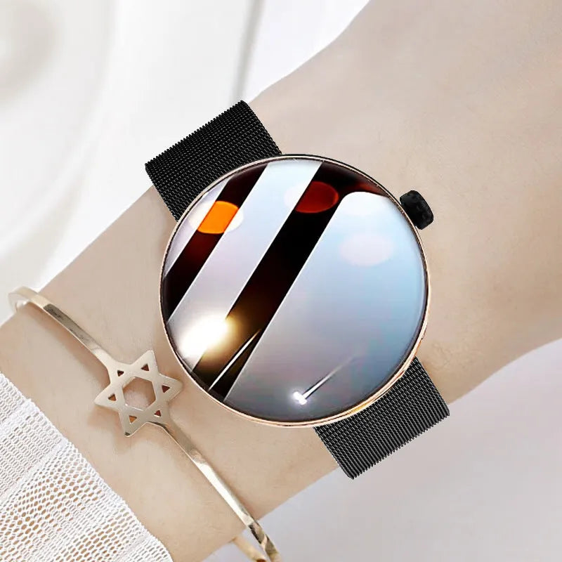 Circular smartwatch for women with metal strap and colour touchscreen on a wrist.