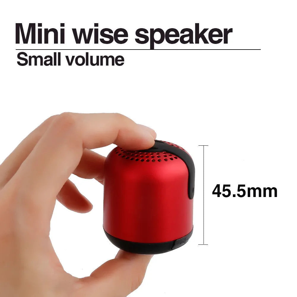Hieha XQ11 cylindrical mini portable Bluetooth speaker in silver colour on a table.