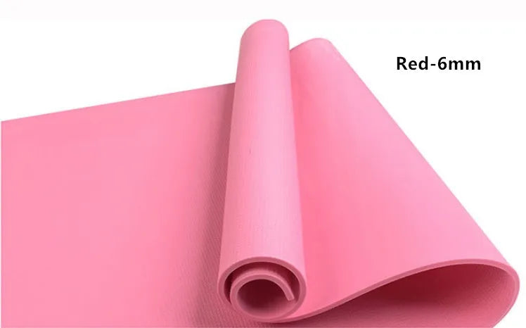 Red EVA fitness yoga mat showing texture and thickness, rolled partially with carry bag.