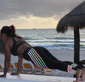 Women's black and white workout leggings with night glowing print, showing slim fit pencil pants style.