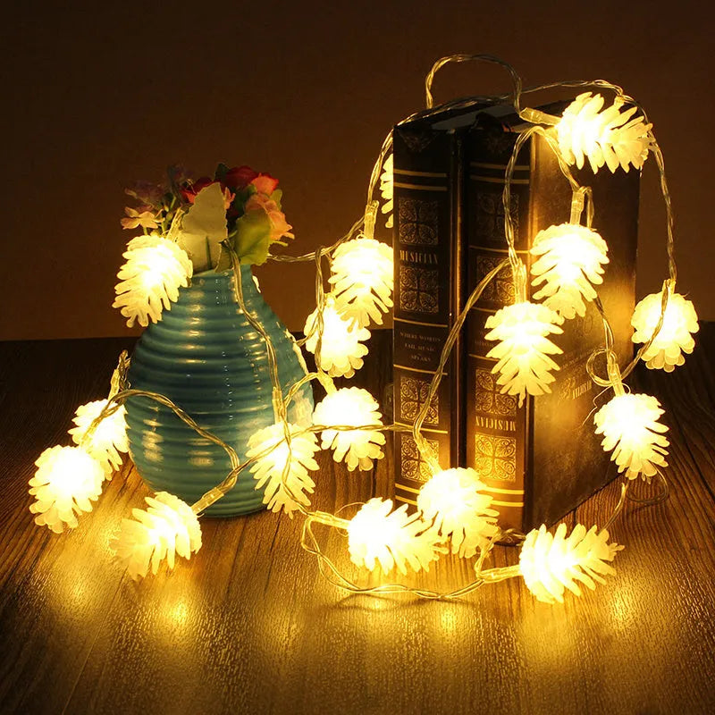 Battery-operated warm white LED string lights with pine cone shaped plastic shells.