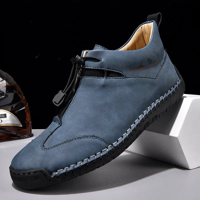 Men's black casual leather shoes with a mid-heel and rounded toe on a neutral background