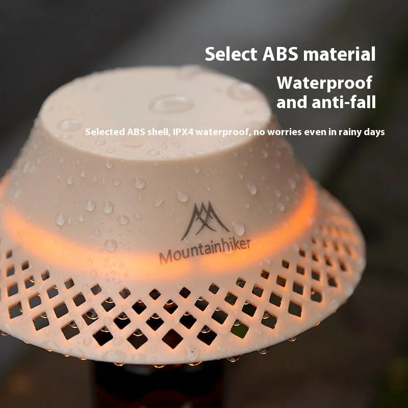 Beige and grey camping lantern with wine bottle-shaped shade showing USB-C port and light modes.
