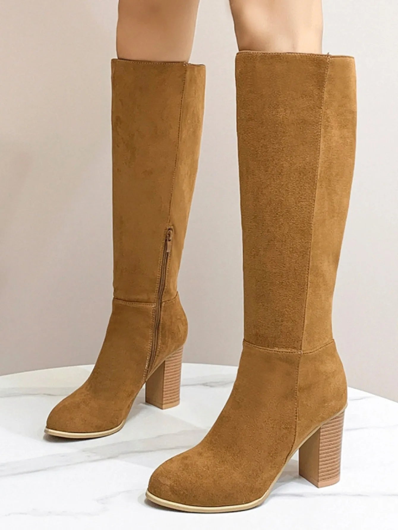 Women's black square toe high heel fashion boots made from artificial PU material.