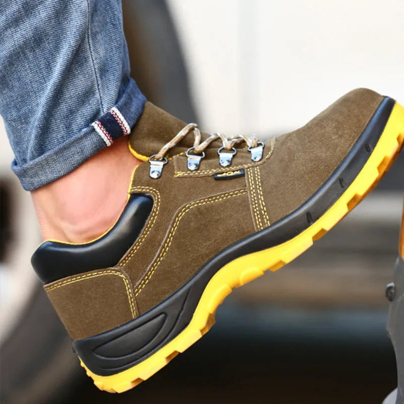 Bronze coloured low-cut cow suede safety work boots with a steel toe cap on a grey background