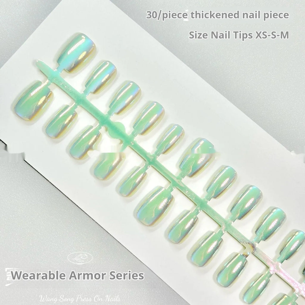 Cat's Eye electroplated false nails set with aurora glow in short ladder sizes on a hand.