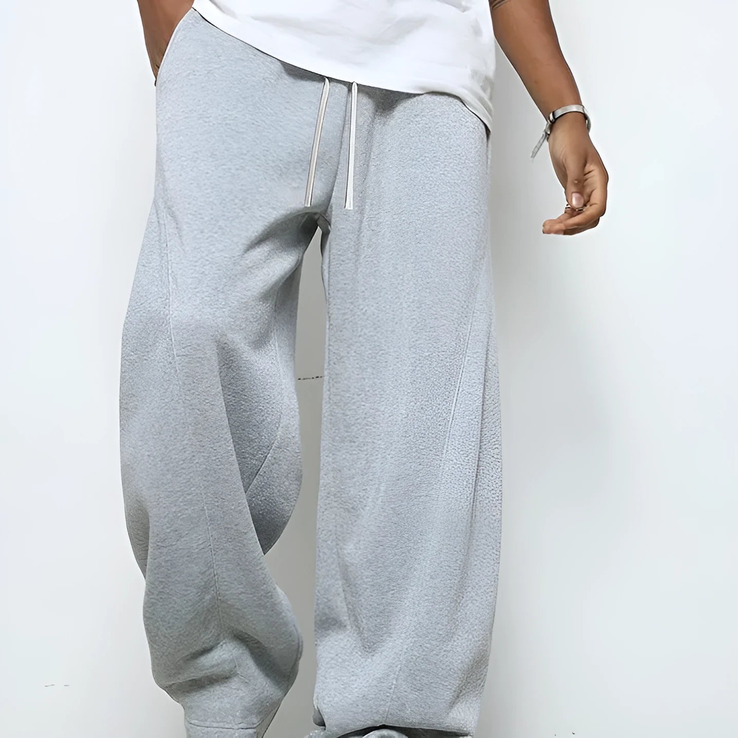 Men's straight-leg casual trousers in black with a drawstring waist, shown flat.