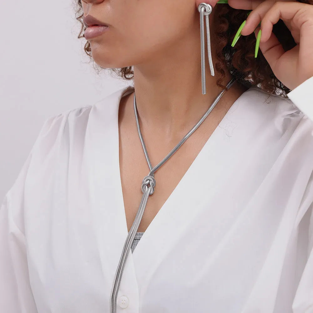 Gold titanium steel necklace with knotted tassel pendant and matching earrings set