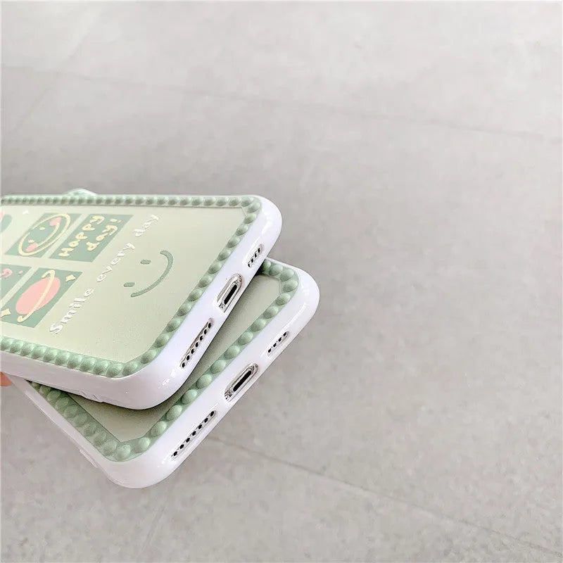 Green geometric pattern TPU iPhone case with polka dot frame and smiley faces, shown from the back.