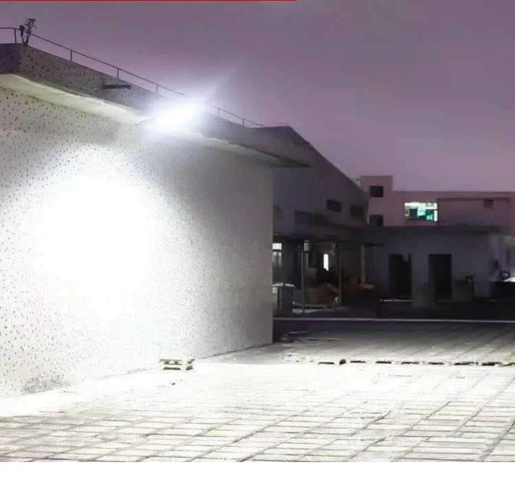 Black outdoor solar motion sensor light for garden or pathway mounting.