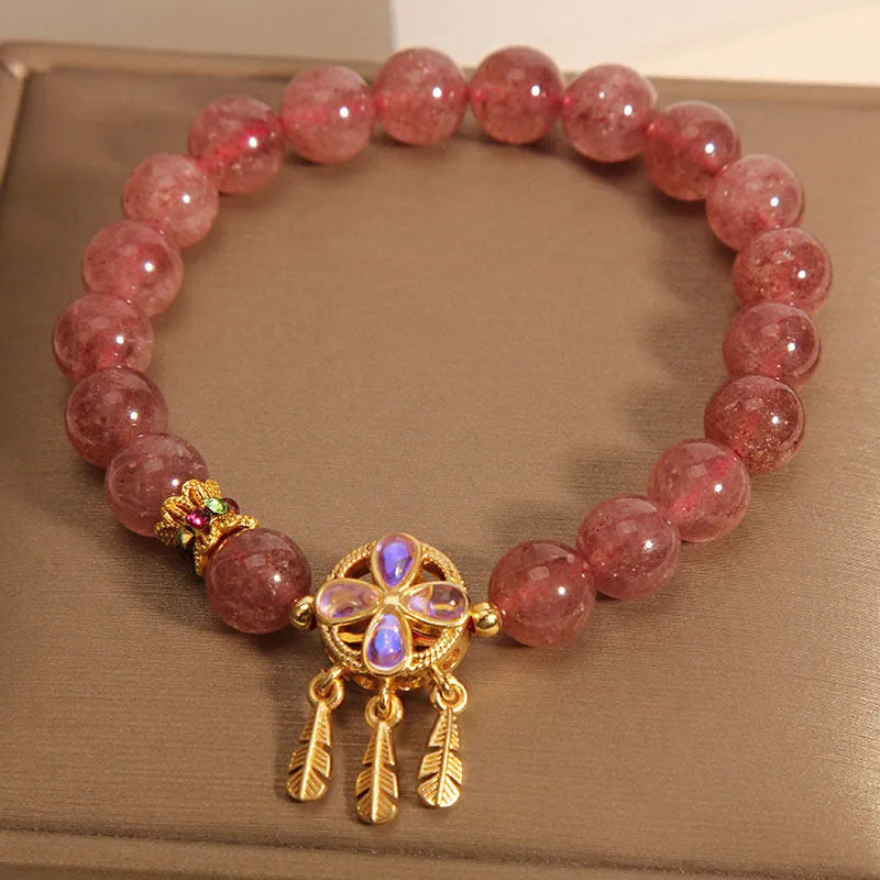 Women's bracelet with a strawberry quartz dream catcher ball pendant on a crystal chain.