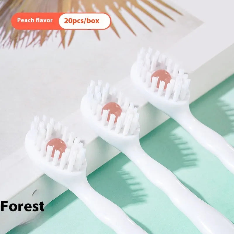 Box containing 20 small white disposable bead toothbrushes with compact rounded heads for travel.