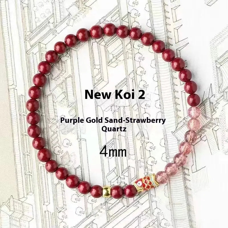 Purple cinnabar and strawberry quartz bracelet with koi and peach blossom design on a wrist.