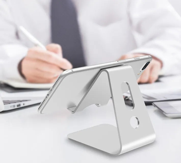 Aluminium universal stand holding a smartphone and a tablet at an adjustable angle.