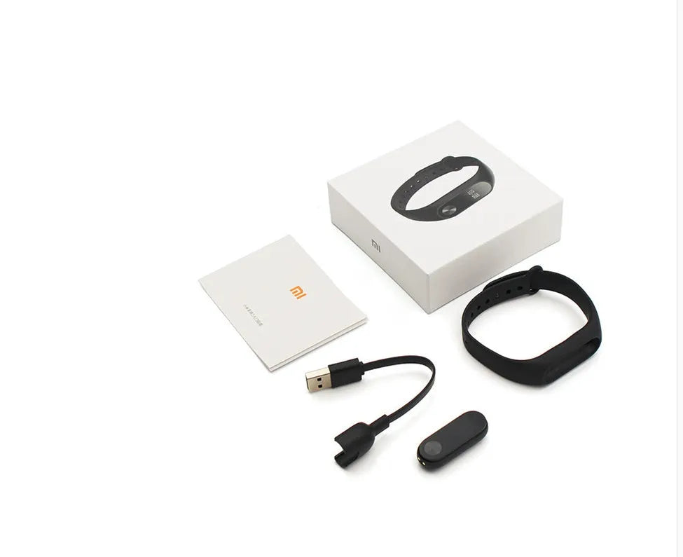 Black Xiaomi Mi Band 2 fitness tracker with OLED screen on a wrist.