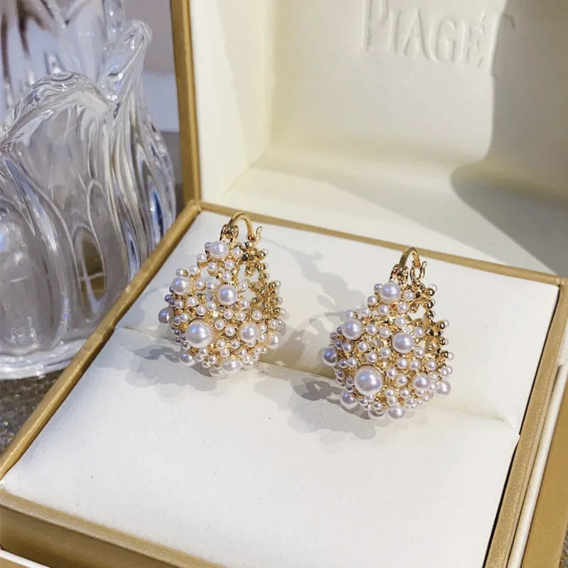 Gold-coloured copper flower basket earrings with pearl inlay and small rice-shaped bead detailing