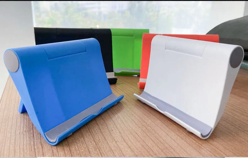 A black PE plastic folding stand holding a mobile phone at an angle, showing its compact design.