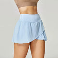 Women's solid colour quick-dry nylon sports shorts with built-in briefs for fitness.