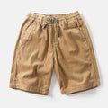 Men's khaki polyester cargo shorts with a straight leg cut on a plain background.