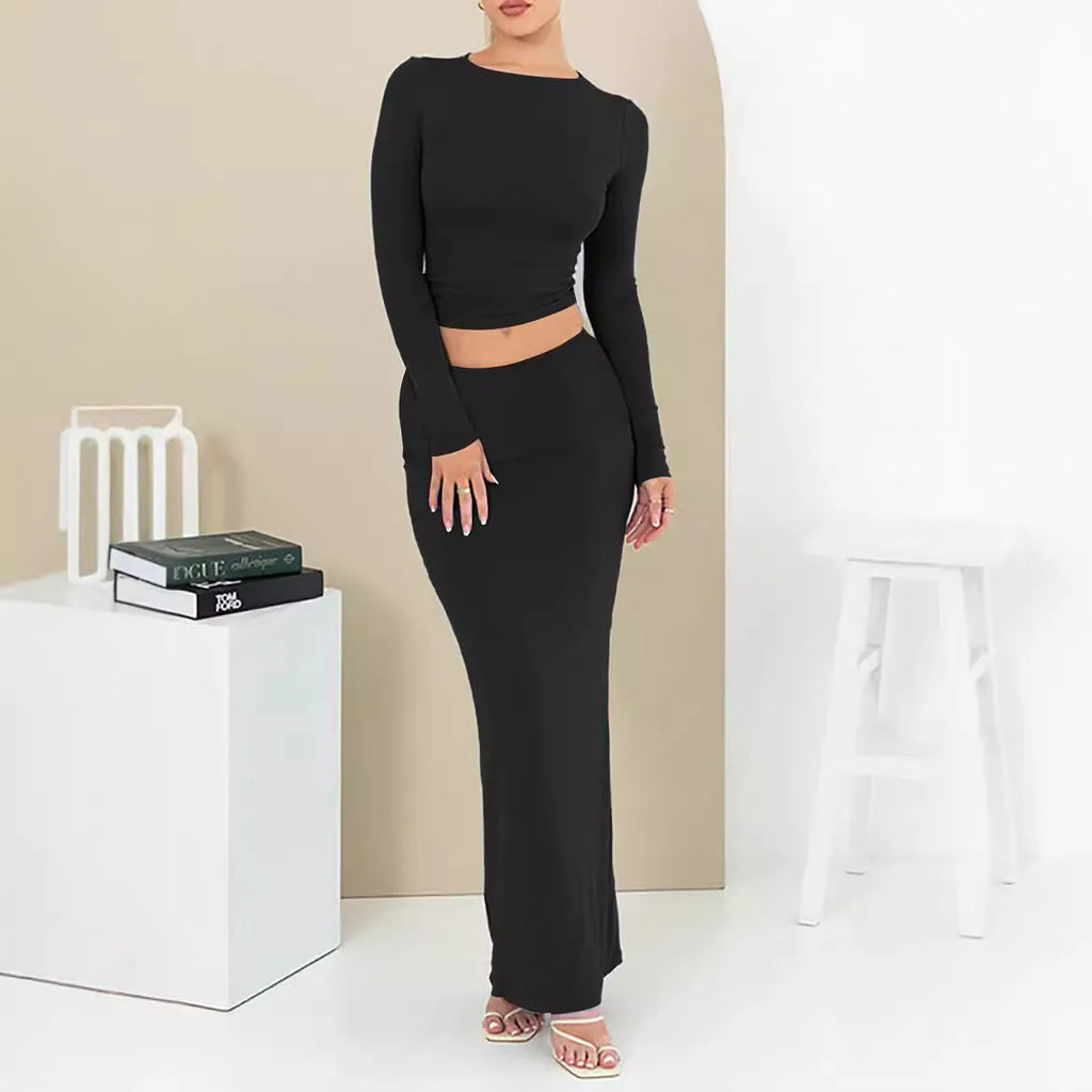 Women's black slim fit polyester two-piece suit with three-quarter sleeves and a long skirt.