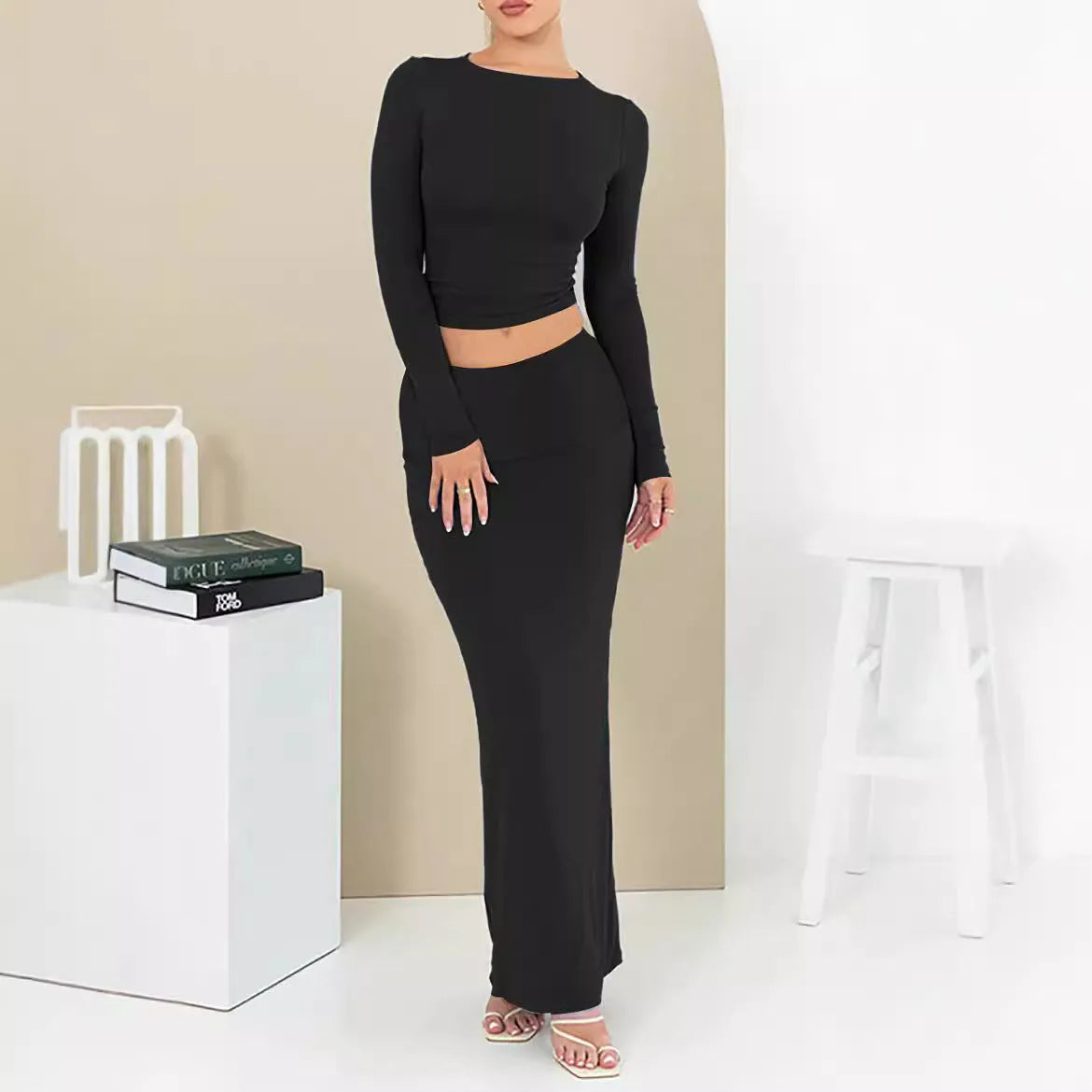 Women's black slim fit polyester two-piece suit with three-quarter sleeves and a long skirt.