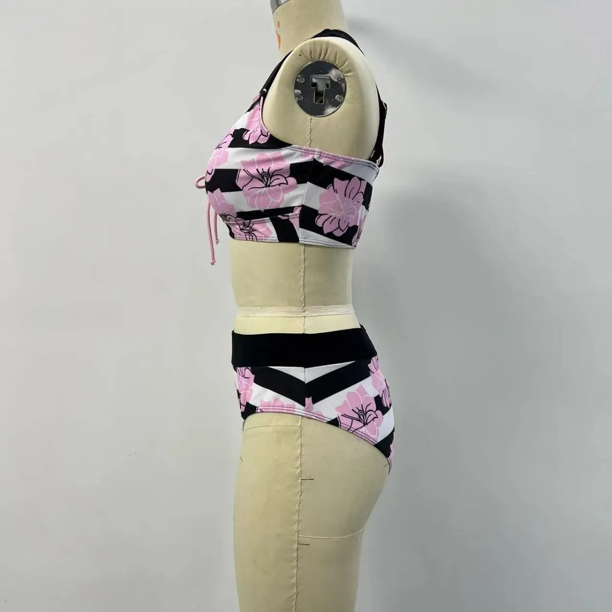 Black printed women's bikini with slimming belly panel and split-leg bottoms.