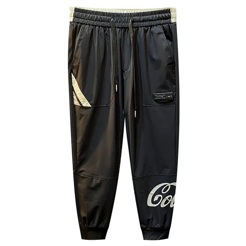 Men's solid black cropped trousers with banded ankle cuffs made from thin ice silk cotton fabric.
