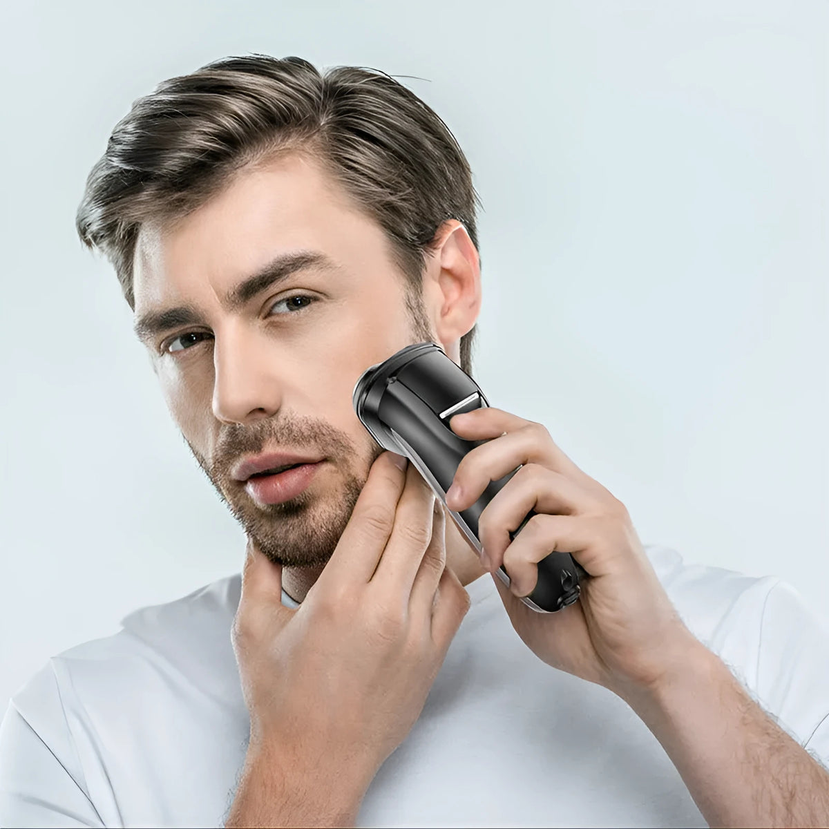 Men's electric shaver with three rotating heads and pop-up sideburn trimmer on black background