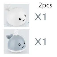Electric whale bath toy spraying water with flashing LED lights in baby bath