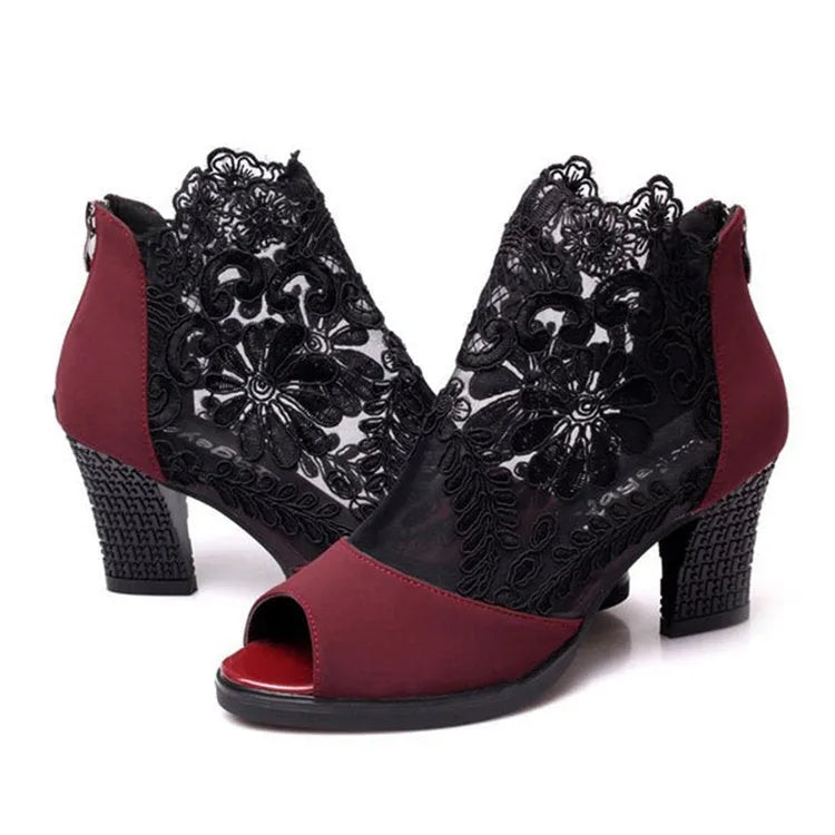 Black gladiator sandals with lace upper, square high heel, and zip closure on ankle