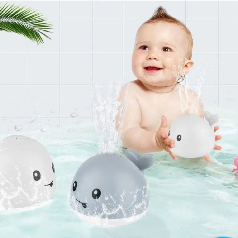 Electric whale bath toy spraying water with flashing LED lights in baby bath