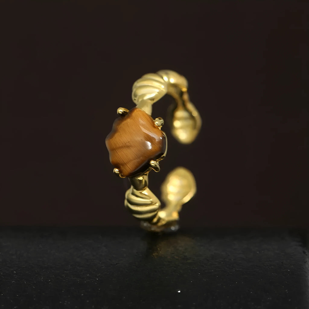 Adjustable silver ring with shell and tiger eye decoration in white gold or 18K gold electroplated finish.