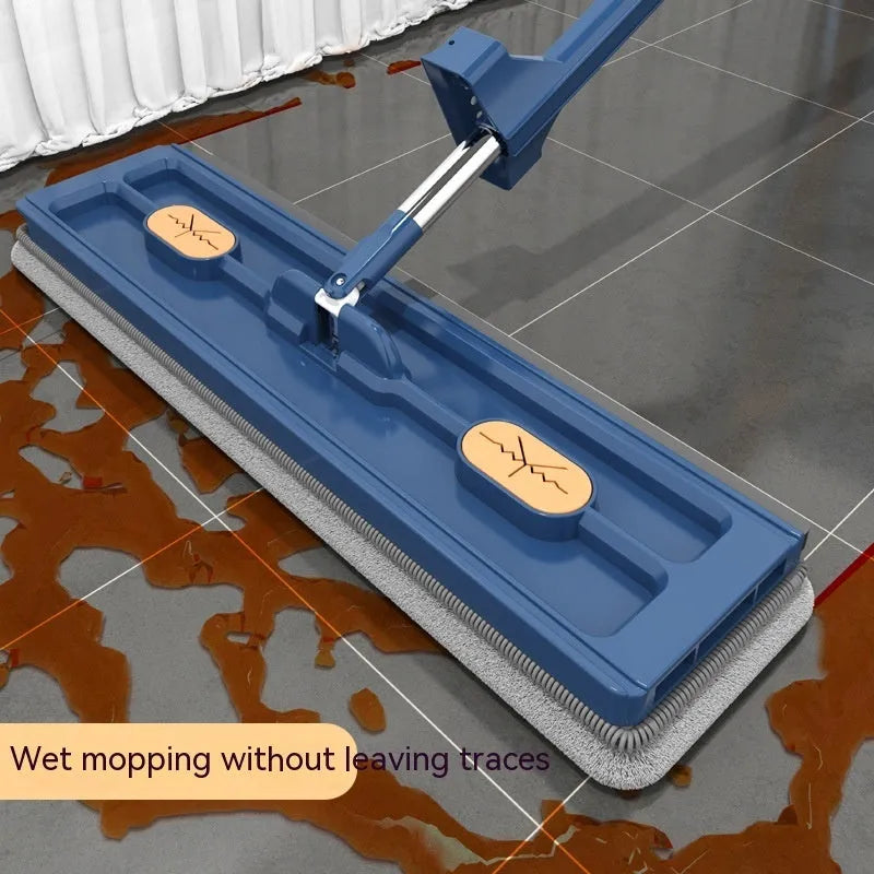 Large flat mop with blue rotating head and long stainless steel handle on a wooden floor