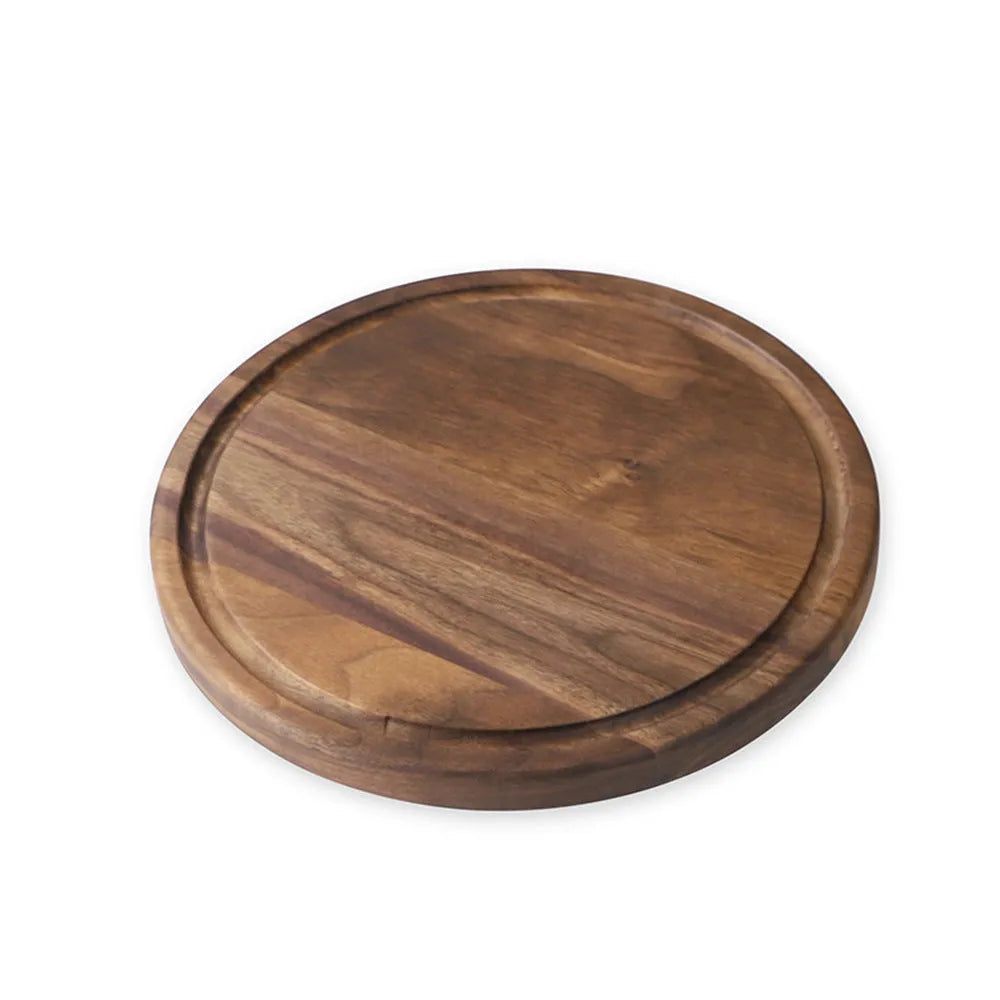 Black walnut wood chopping board with juice groove, shown in round and rectangular sizes on a kitchen counter.