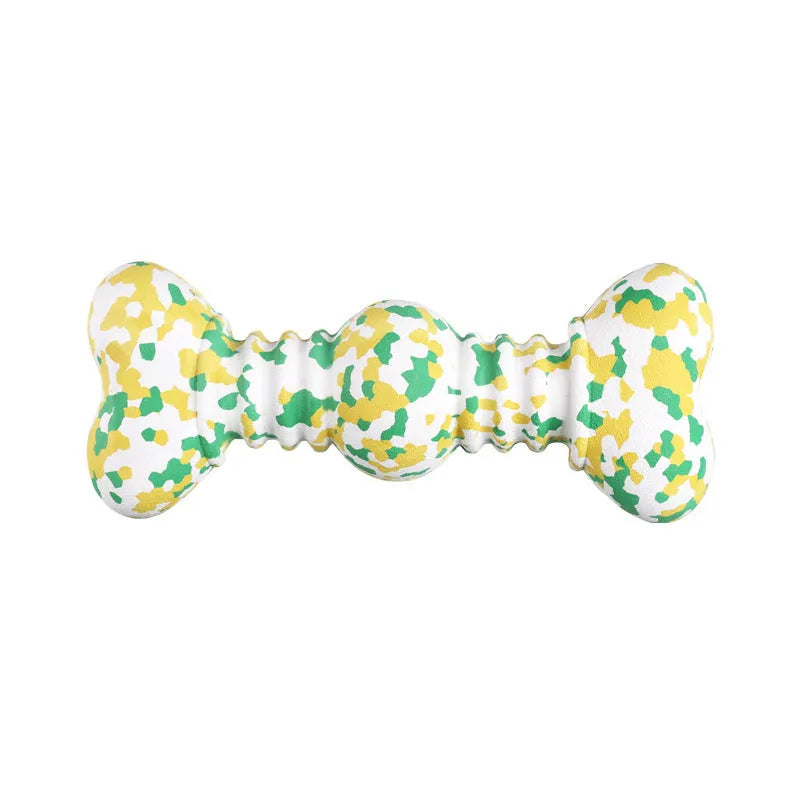 Green and white camouflage patterned natural rubber bone-shaped dog chew toy for large dogs on a wooden floor.